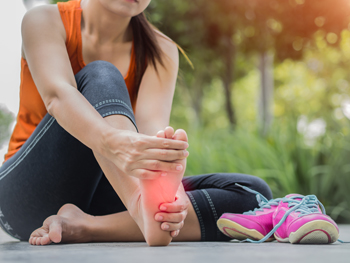 Running Injuries model holding Feet