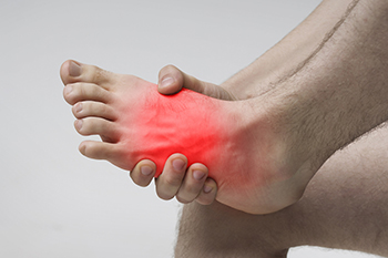 Patient model holding a painful foot