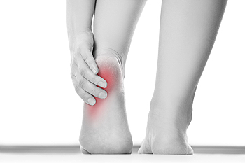 Foot model holding Heel in Pain