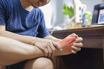 Gout patient holding foot